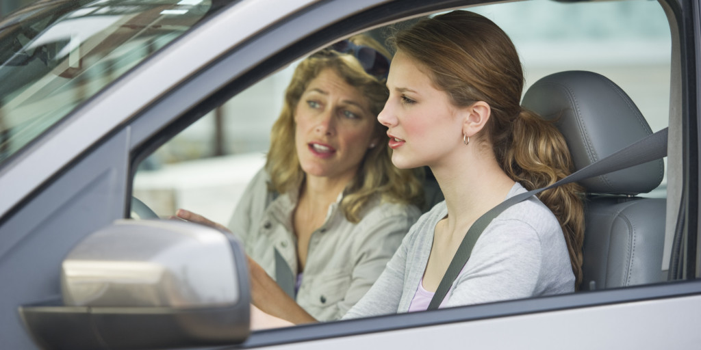 Mother teaching her daughter how to drive