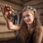 Teen holding set of keys whose parents are deciding if they should buy their teen a used car in Gillette Wyoming.