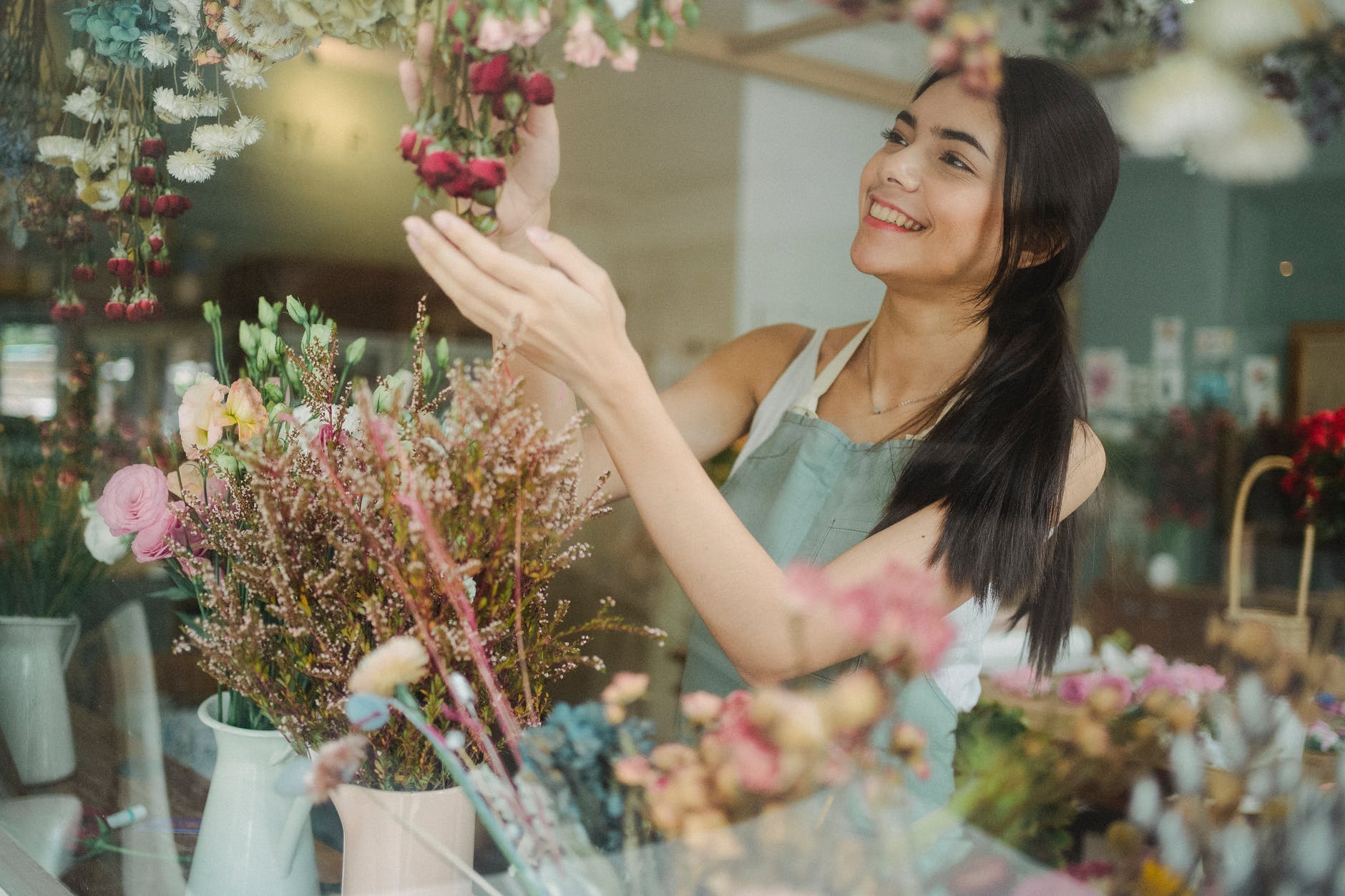happy woman making bouquets of flowers