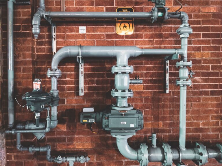 Plumbing and Pipes on a Brick Wall.