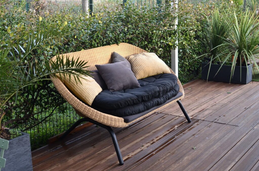 4 Summer Home Projects to Increase Your Home’s Value 1 cozy rattan sofa with cushions in tropical garden