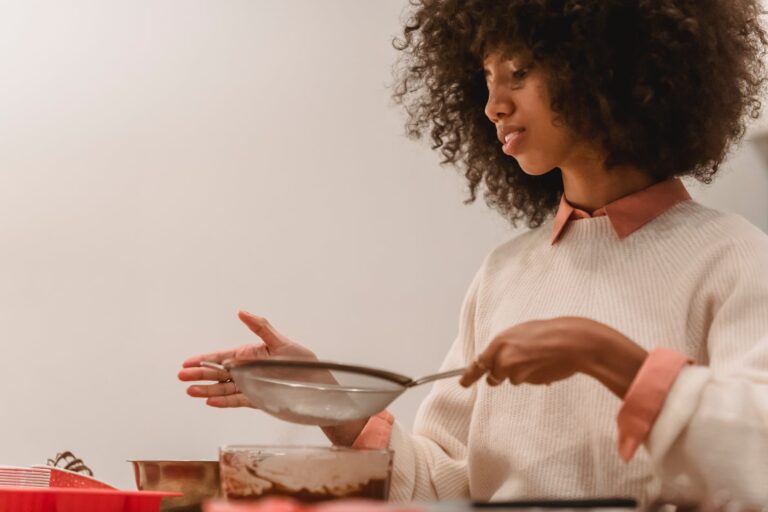 skilled black woman sifting flour