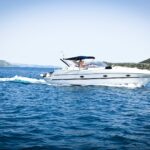 white speedboat on body of water