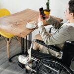 disabled woman taking photo of coffee in cafe