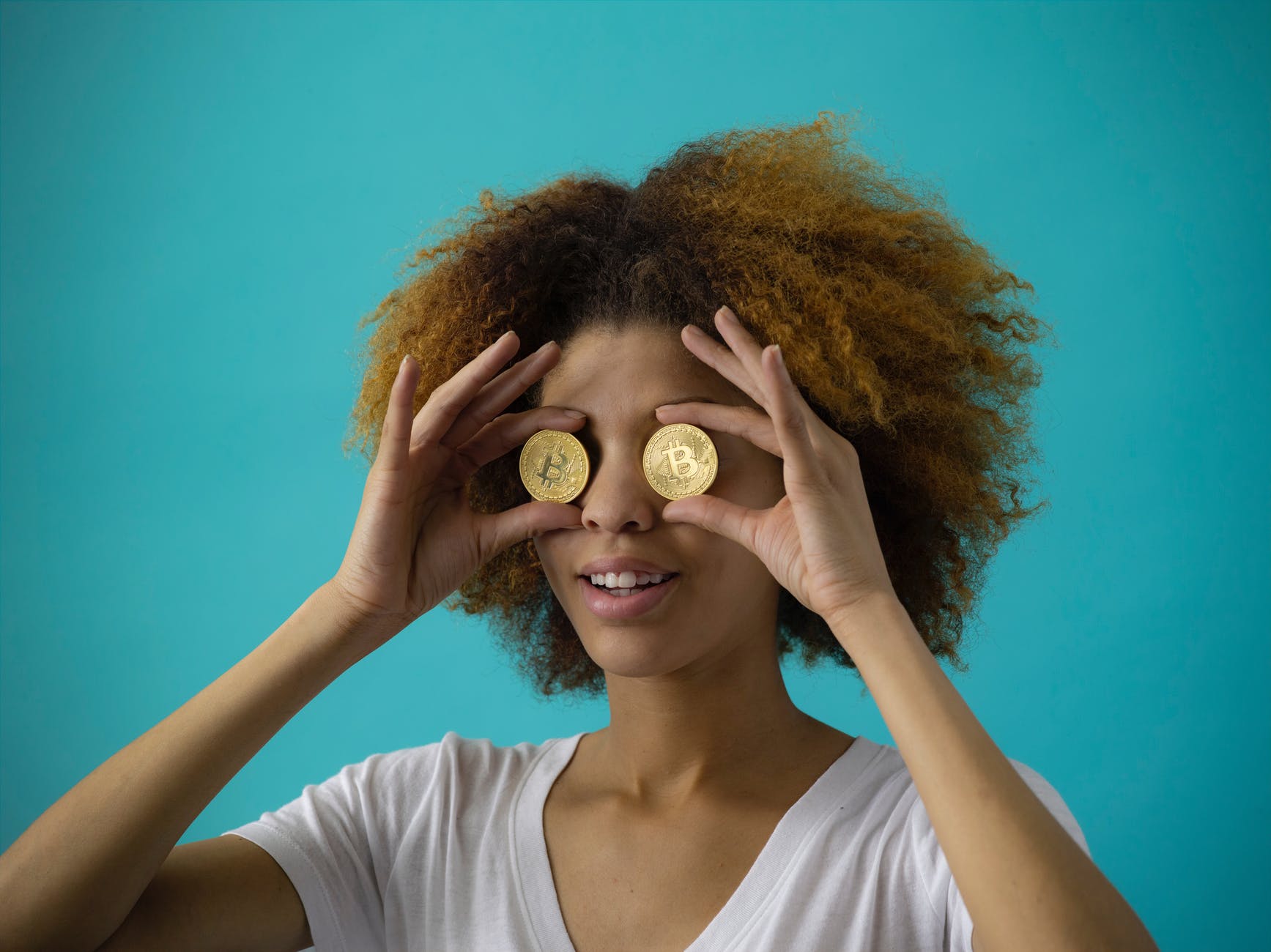 woman holding two coins