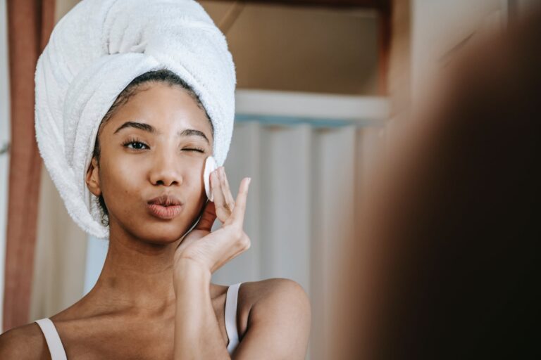 ethnic woman with folded lips doing skin care procedure