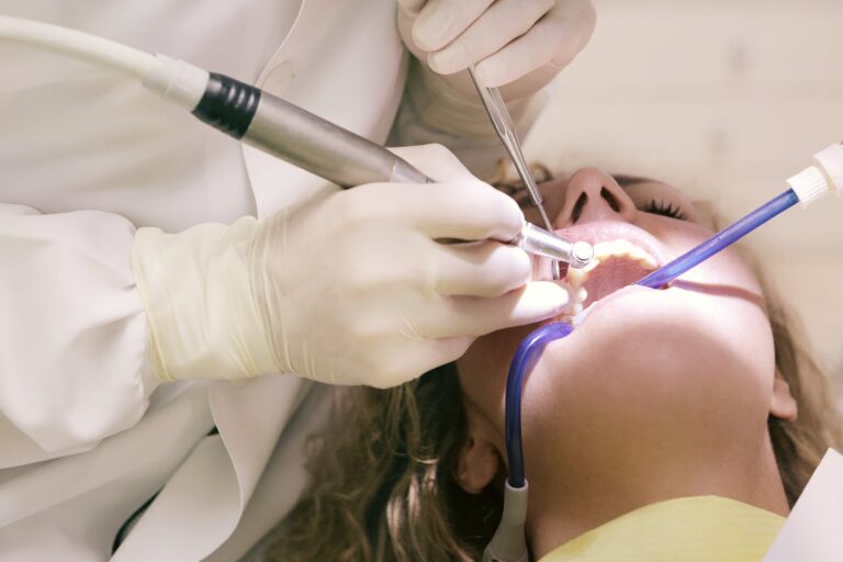 dentist working working on woman s teeth