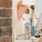 a woman painting a wall