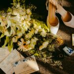 pair of beige shoes beside bouquet