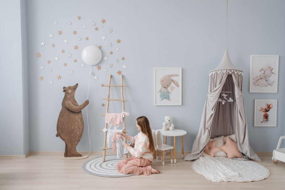 How To Plan & Design Your Nursery 1 a woman holding baby clothes