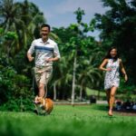 man and woman running near green leaf trees photo