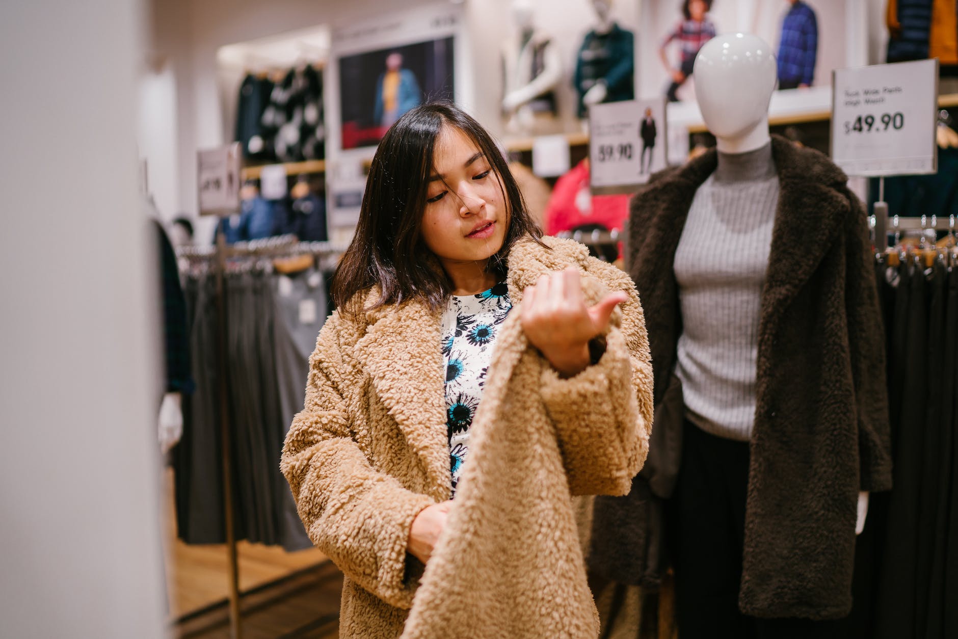 woman checking price near mannequin