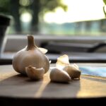 photography of garlic on wooden table