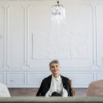 man in black suit sitting on chair