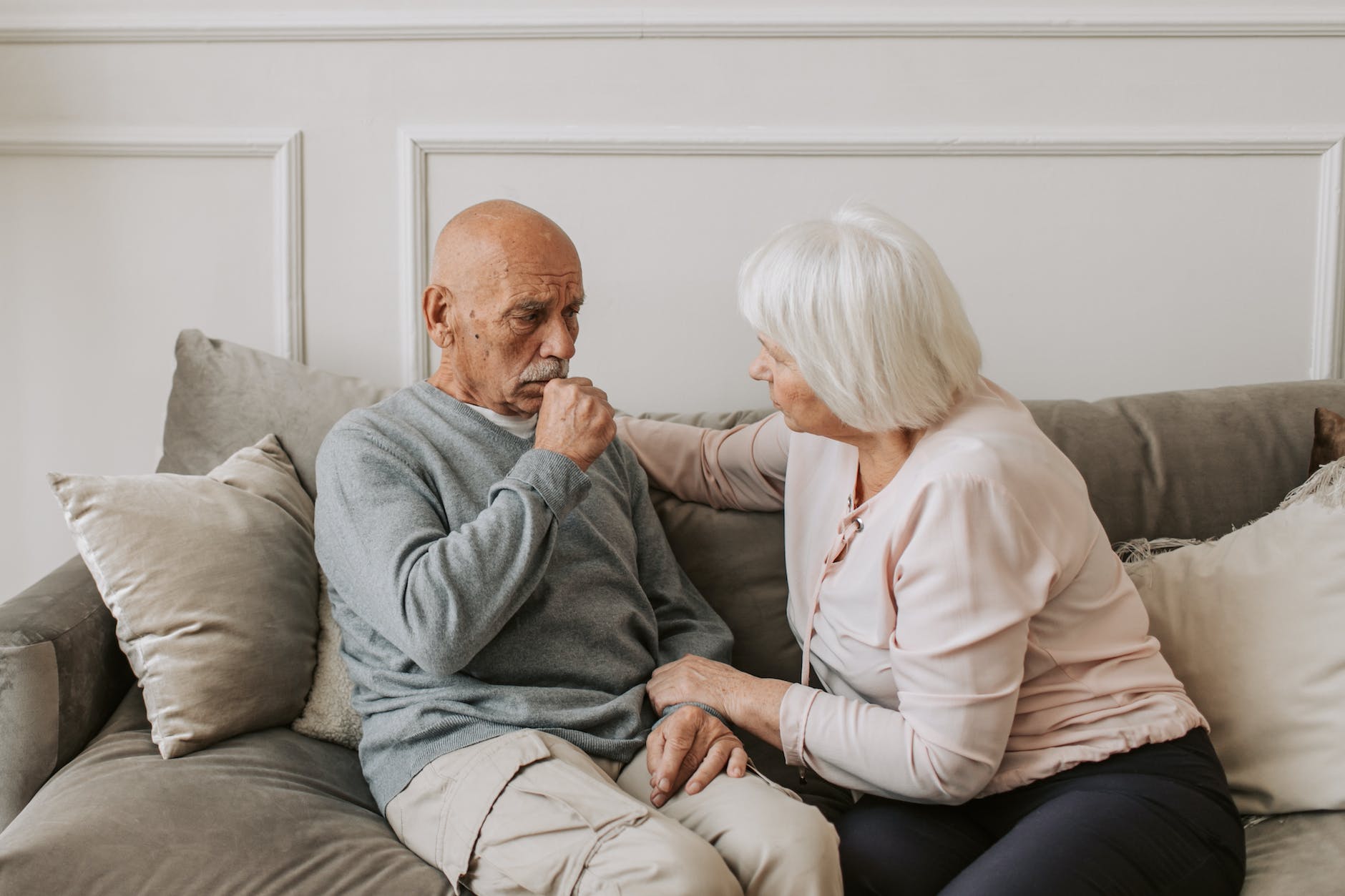 man in gray sweater sitting beside woman