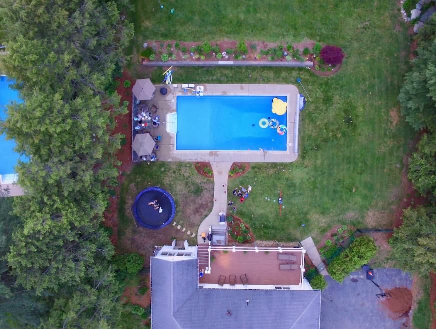 Aerial view of an outdoors, backyard pool