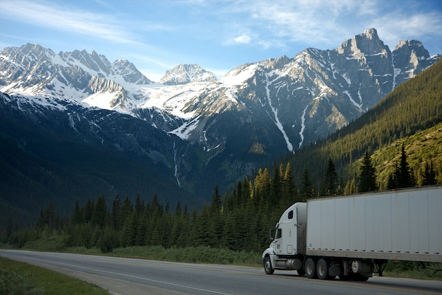 A truck driving past mountains