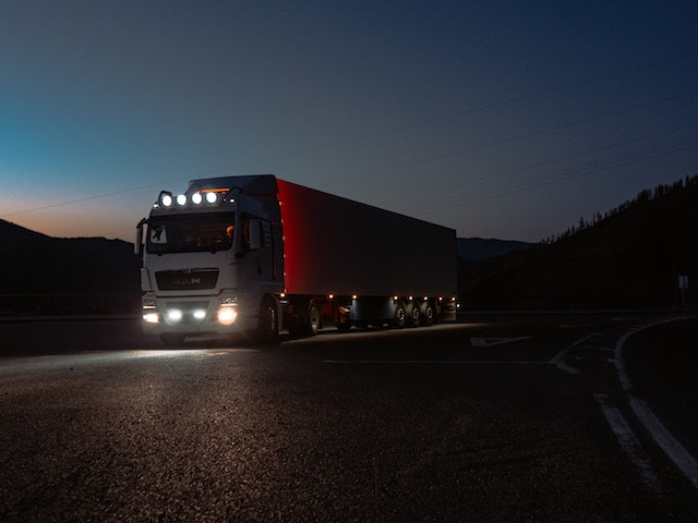 a truck driving down a dark road