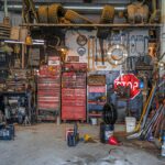 A very cluttered garage that would be hard to do anything in