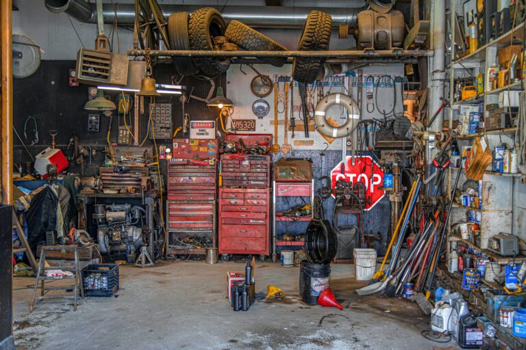 A very cluttered garage that would be hard to do anything in