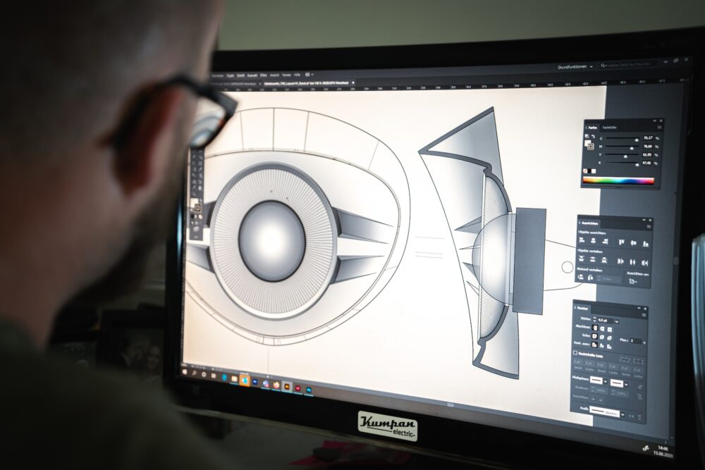 A person working at a computer to digitally design a product