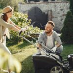 woman in brown long sleeve shirt holding grass cutter