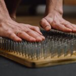 a person leaning on bed of nails