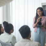 a woman giving presentation to colleagues