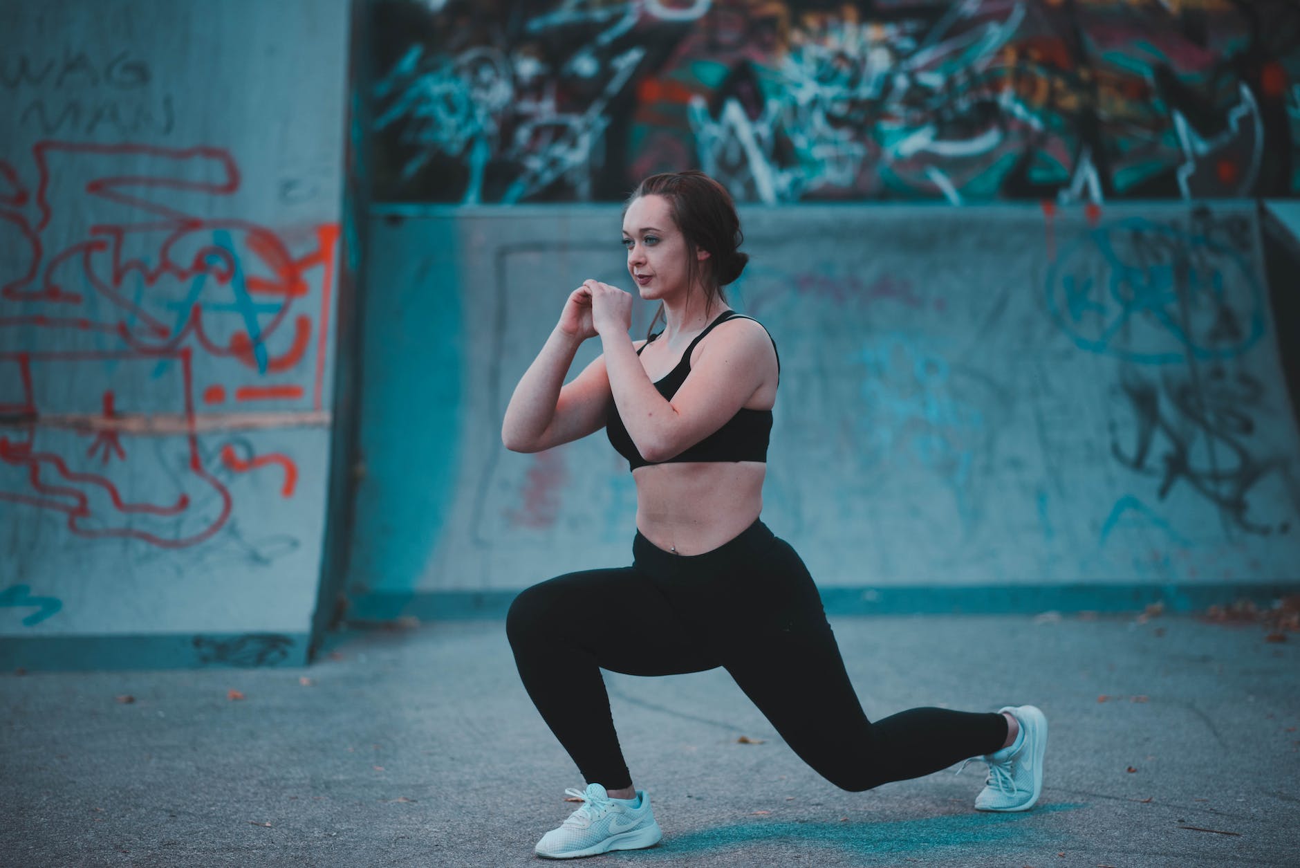 woman stretching beside wall