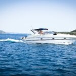 white speedboat on body of water