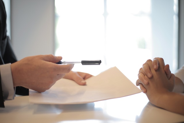 A person signing papers for a mortgage