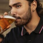 A man drinking a beer