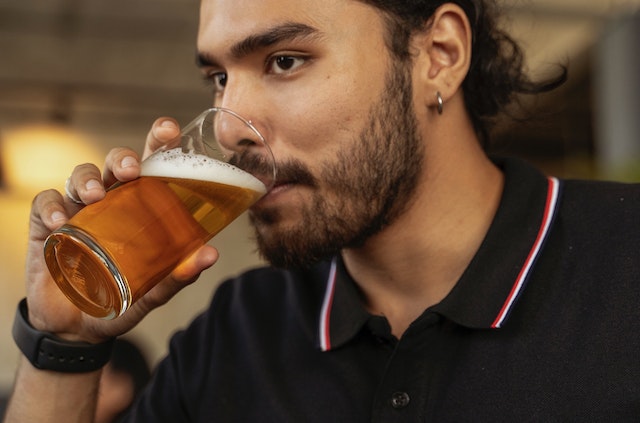 A man drinking a beer