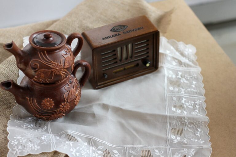 antique teapots with patterns and a radio