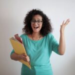 adult displeased businesswoman with papers in light modern office