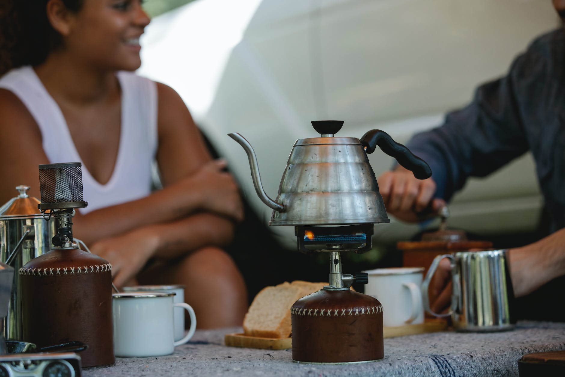 crop friends preparing coffee and boiling kettle on gas stove