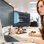 Young woman sitting at computer.