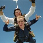 Photo of two people skydiving.