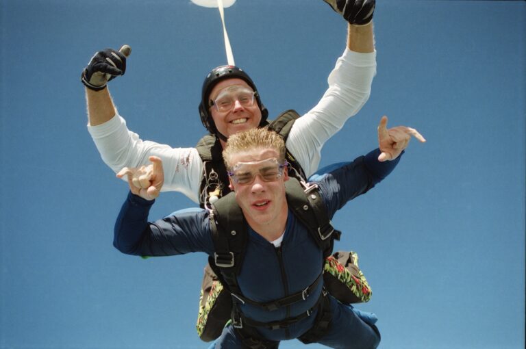 Photo of two people skydiving.