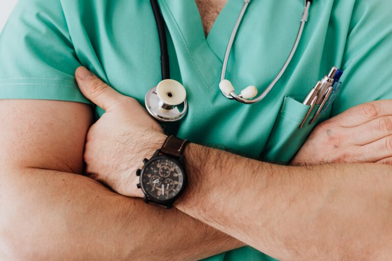 Close up shot of doctor with their arms crossed.