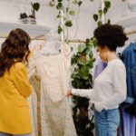 Two women standing in a store shopping together.