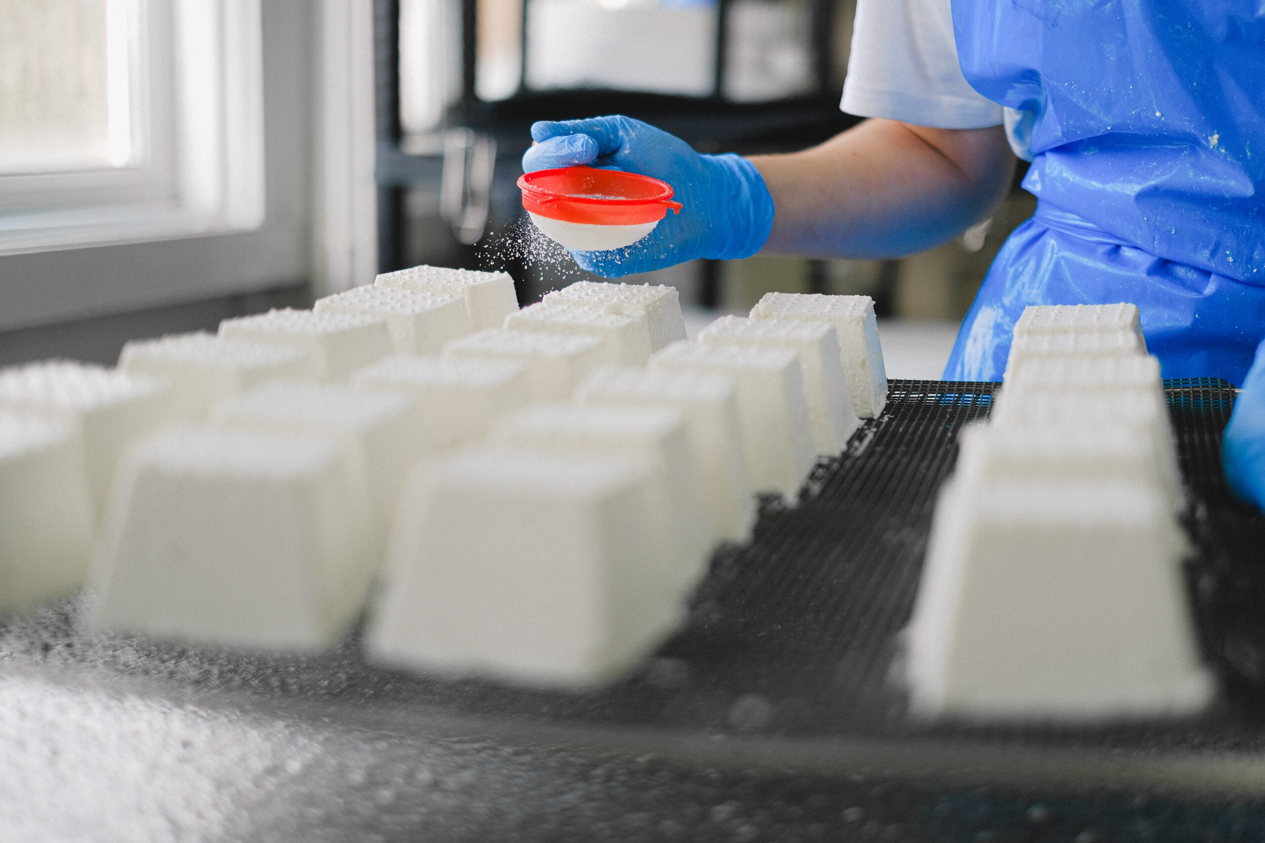 Person in factory making food.