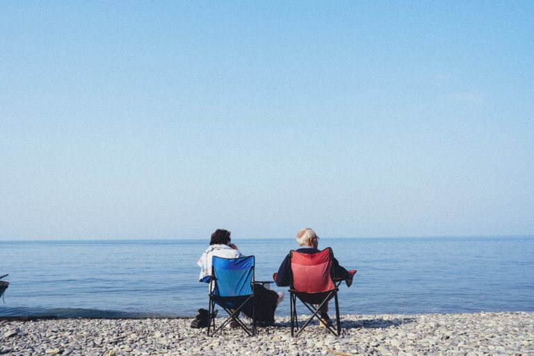 elderly couple relaxing on beach