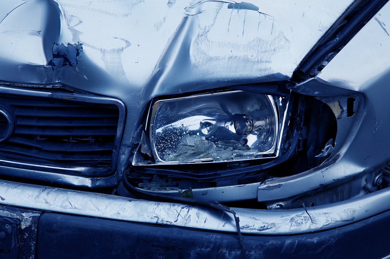 Zoomed in photo of the front headlight on a car after a crash.