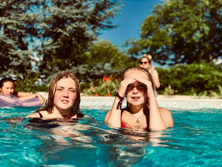 Girls in pool looking at the camera.