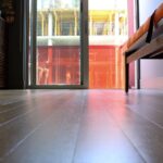 A view from the floor of a sliding door leading outside of a home.