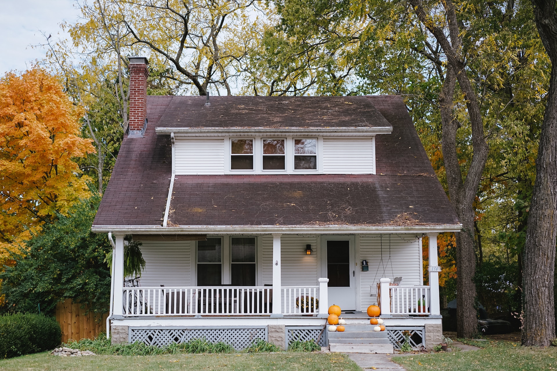 A house with a very scuffed roof, presumably from high winds or hail