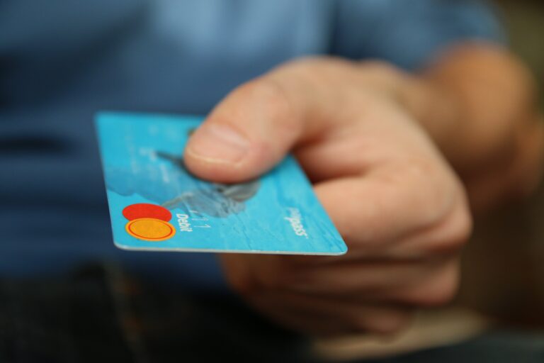Close-up of person holding a credit card.