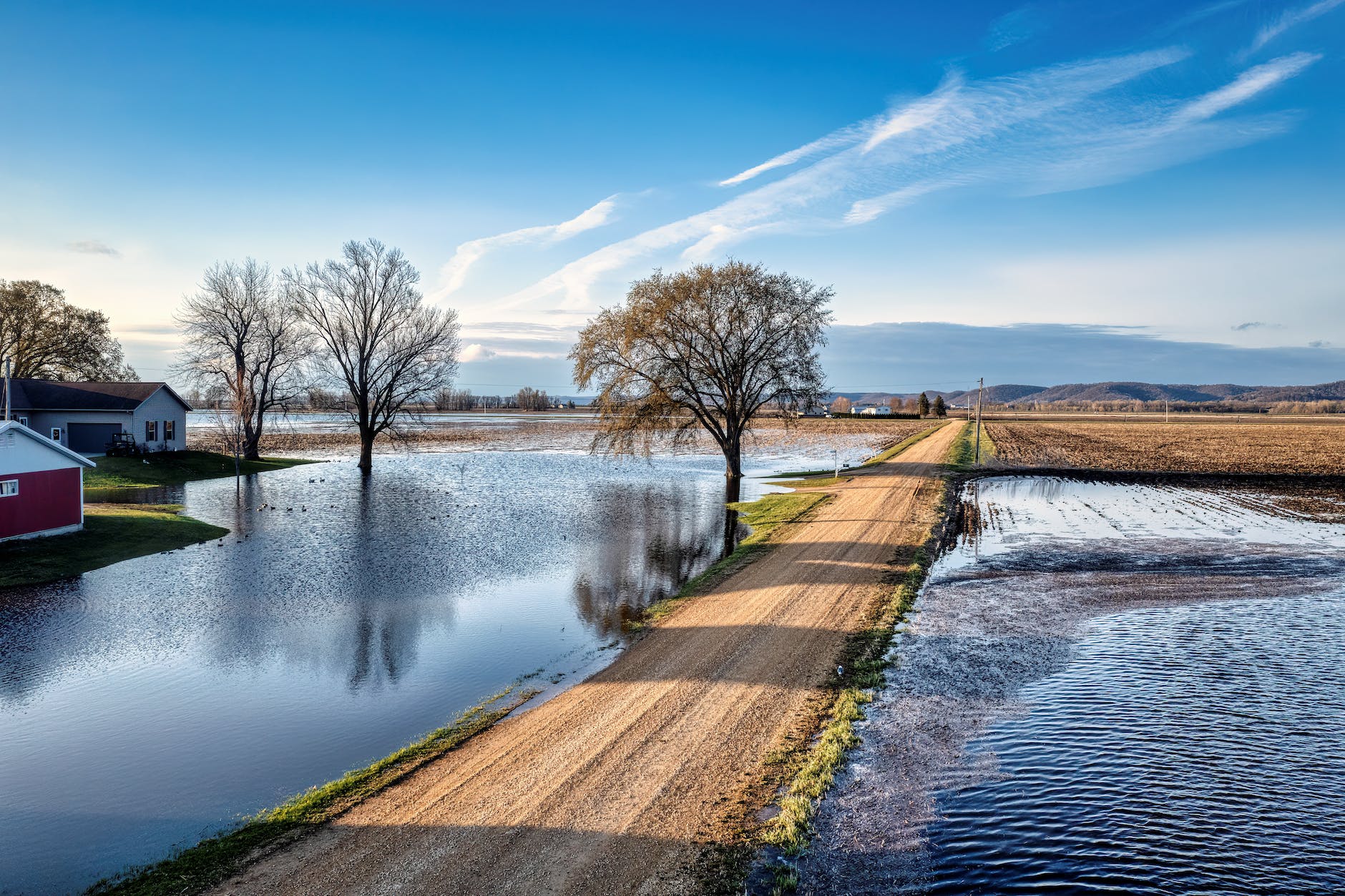 dirt road among flooded fields