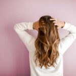 A woman brushing back her hair